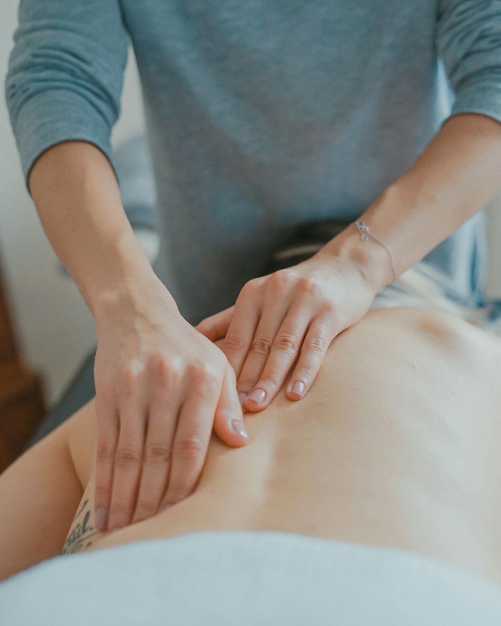 A massage being worked through a client's back